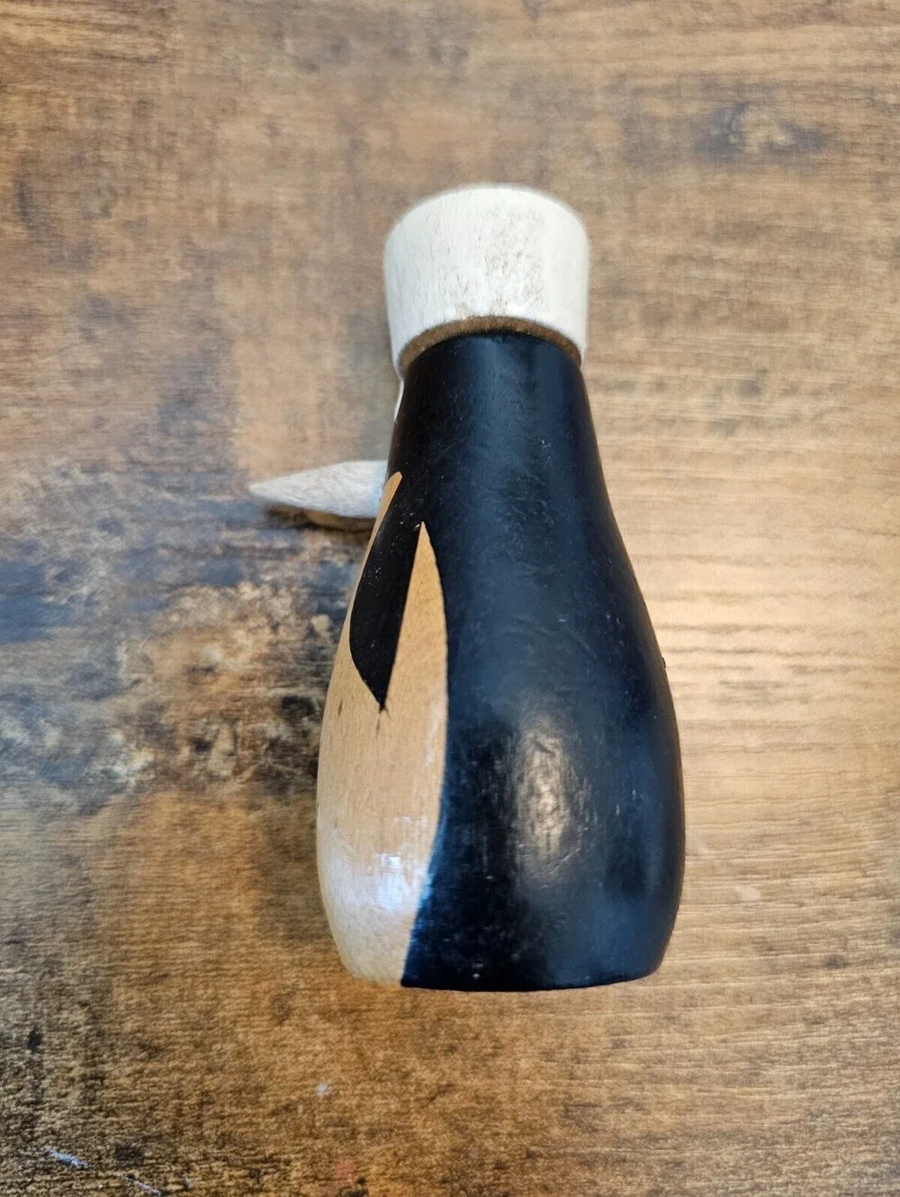 Vintage hand-painted wooden pepper shaker shaped like a penguin